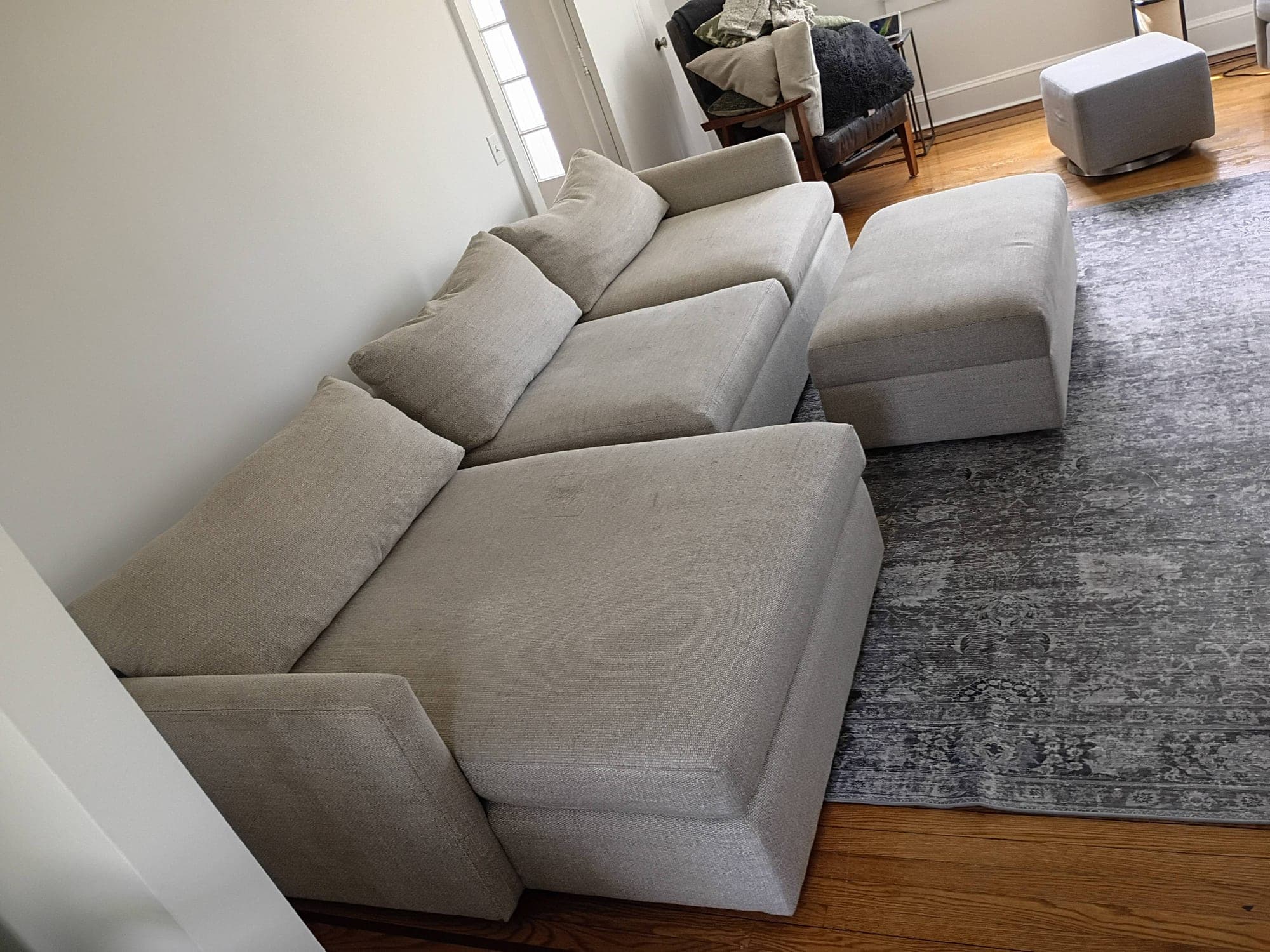 Clean beige sectional sofa in a bright living room after cleaning