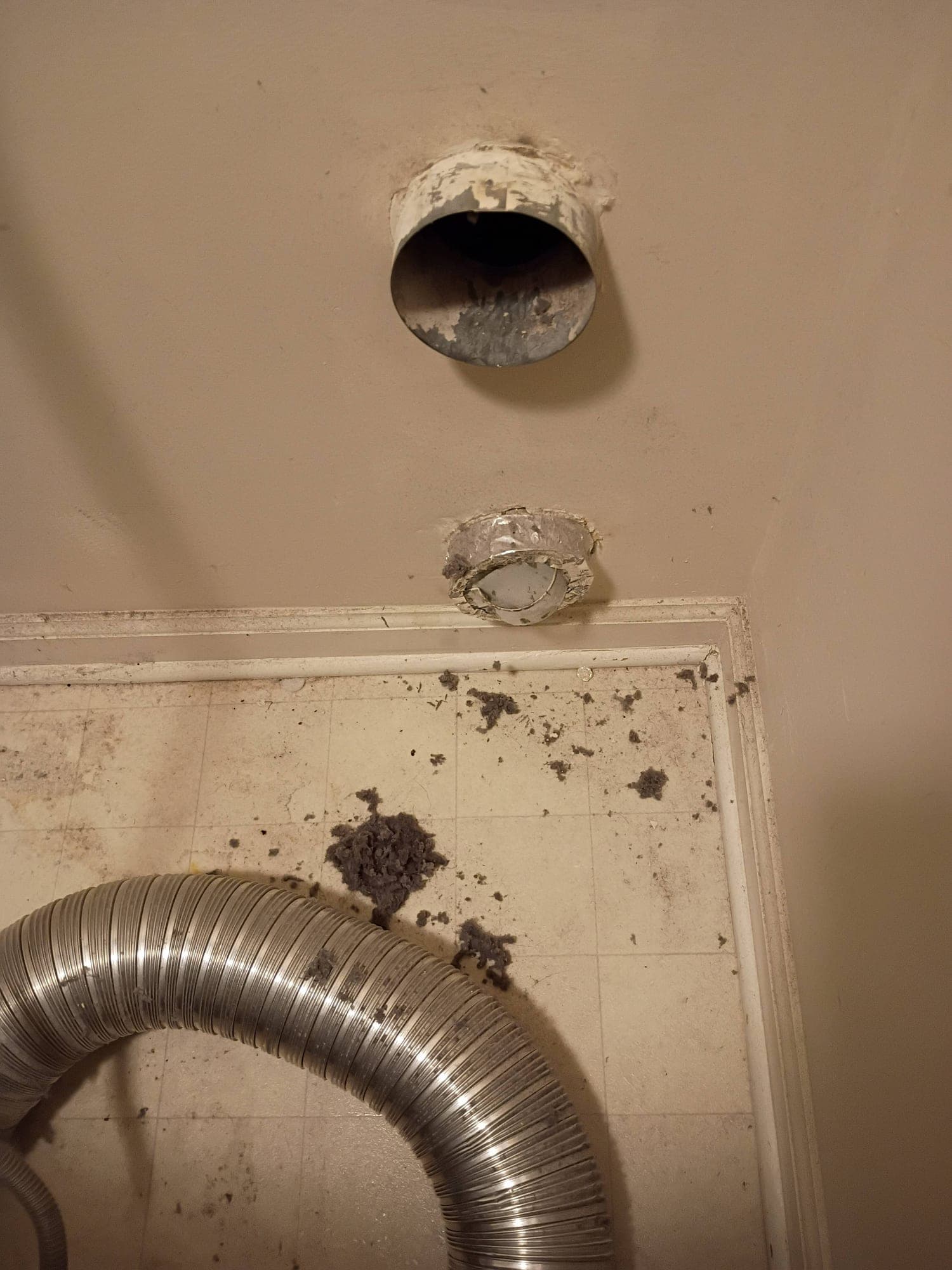 Close-up of an air vent opening thick with dust and lint buildup