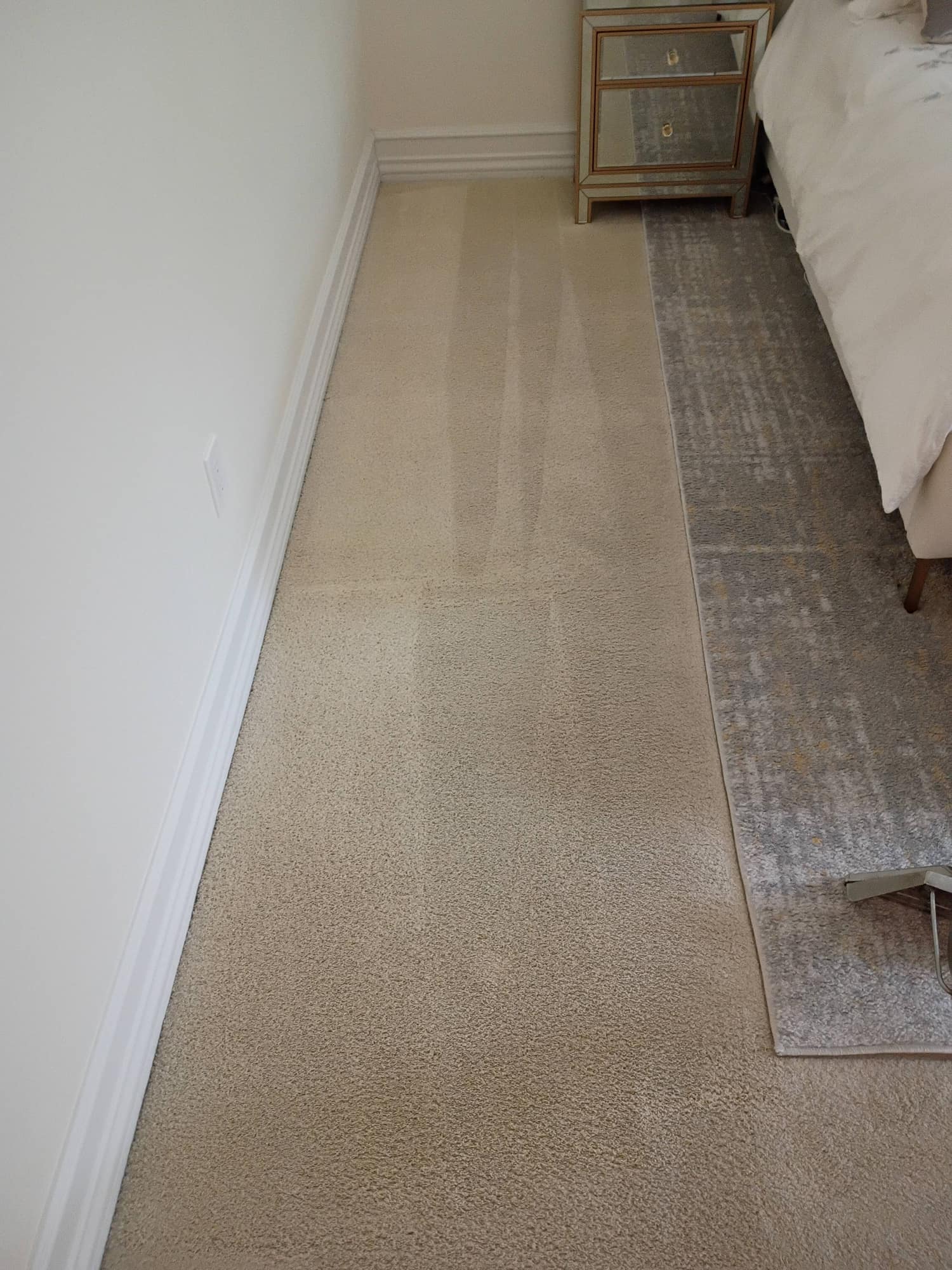 Bright bedroom with window seat and chair after carpet cleaning