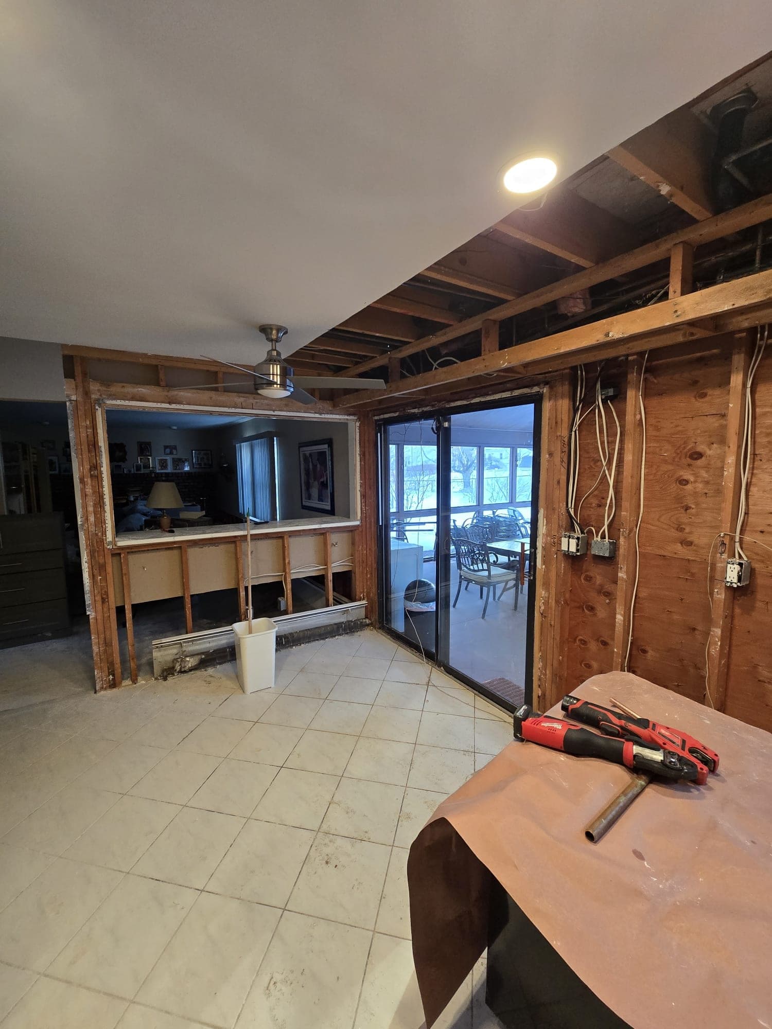 Water-damaged kitchen stripped to studs with pass-through to the living room